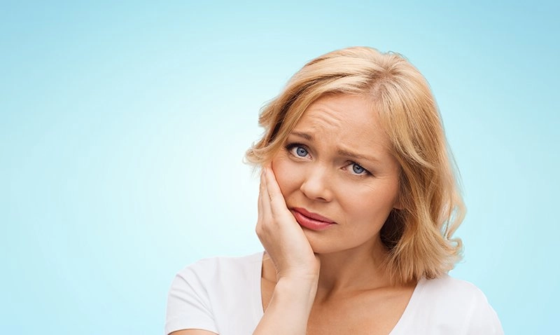 Woman needs Emergency Dentistry Premier Dental Care Boynton Beach FL
