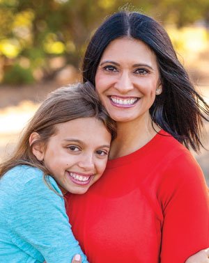 Woman and daughter smiling